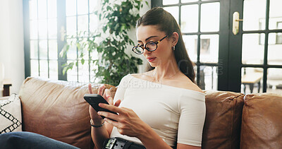 Buy stock photo Phone, relax and woman on sofa in home with networking, communication or chatting on mobile app. Notification, glasses and person with cellphone for online texting, blog or contact in living room.