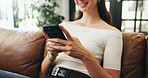 Girl, phone and hands on sofa with typing, communication or texting in home. Student, tech and contact in living room with connection, social media update or weekend planning on couch with networking