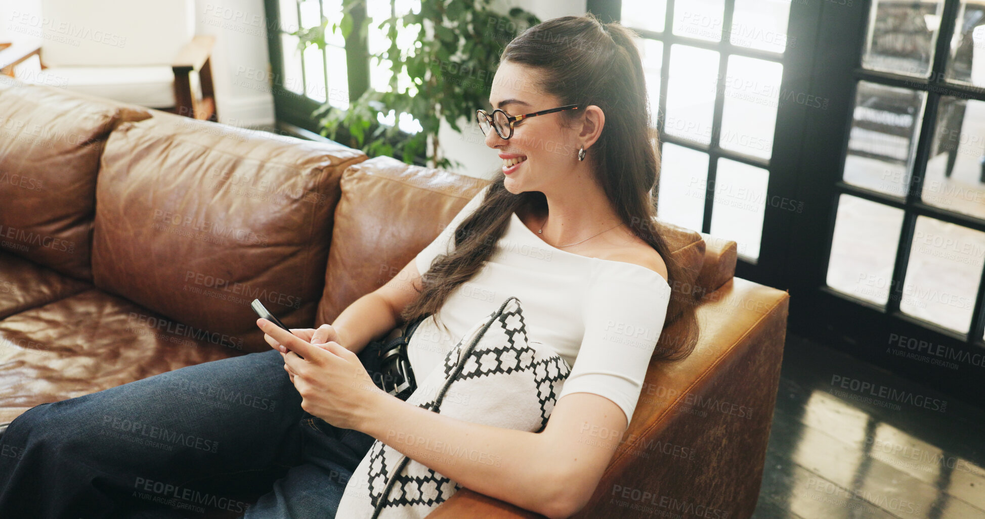 Buy stock photo Girl, phone and relax on sofa with typing, communication or texting in living room. Student, tech and contact in home with connection, social media update or weekend planning on couch with networking