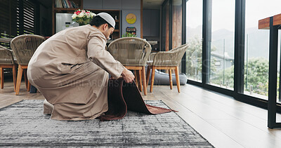Buy stock photo Muslim man, salah and preparation with mat for worship, prayer or islam faith in home. Male person, direction and religion with carpet pointing to qibla for Allah, spiritual connection or praise god