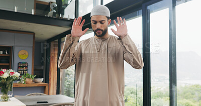 Buy stock photo Muslim, man and praying salah at house with faith, praise Allah and spiritual worship in Ramadan. Islamic, male person and prayer with dua, religious practice and devotion to God for belief in lounge