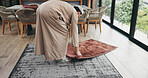 Muslim man, salah and preparation with mat for prayer, worship or islam faith in home. Male person, direction and religion with carpet pointing to qibla for Allah, spiritual connection or praise god