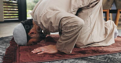 Buy stock photo Islamic, man and praying salah at house with faith, praise Allah and spiritual worship in Ramadan. Muslim, male person and prayer with dua, religious practice and devotion to God for belief in lounge