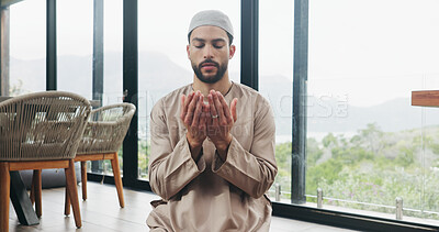 Buy stock photo Muslim, man and praying salah in home with faith, praise Allah and spiritual worship in Ramadan. Islamic, male person and prayer with dua, religious practice and devotion to God for belief in lounge