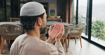 Buy stock photo Islam, man and praying with dua at house for faith, praise Allah and spiritual worship in Ramadan. Male person, thobe and prayer with salah, religious practice and devotion to God with muslim belief