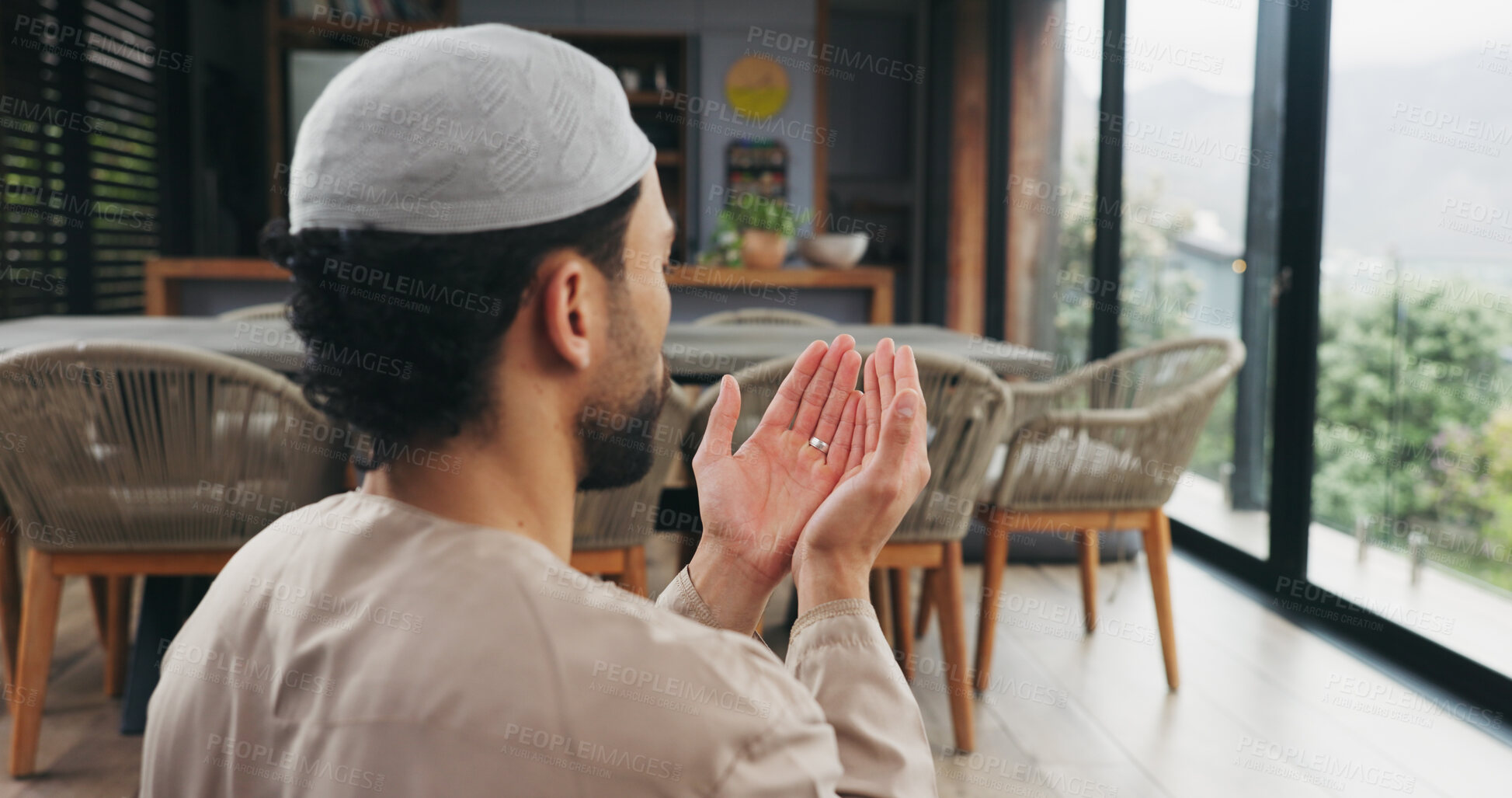 Buy stock photo Islam, man and praying with dua at house for faith, praise Allah and spiritual worship in Ramadan. Male person, thobe and prayer with salah, religious practice and devotion to God with muslim belief