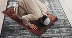 Above, man and praying salah in home with faith, praise Allah and spiritual worship in Ramadan. Muslim, male person and prayer with dua, religious practice and devotion to God with islamic culture