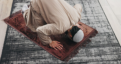 Buy stock photo Above, man and praying salah in home with faith, praise Allah and spiritual worship in Ramadan. Muslim, male person and prayer with dua, religious practice and devotion to God with islamic culture