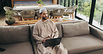 Muslim man, laptop and thinking with remote work from home for decision, review or project management in lounge. Islamic person, computer and writer with insight, feedback and freelance job in house