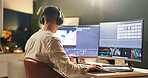 Man, night and video editor with computer for digital marketing or production in office. Back view, male person or creative designer working late with technology for UI development or app design