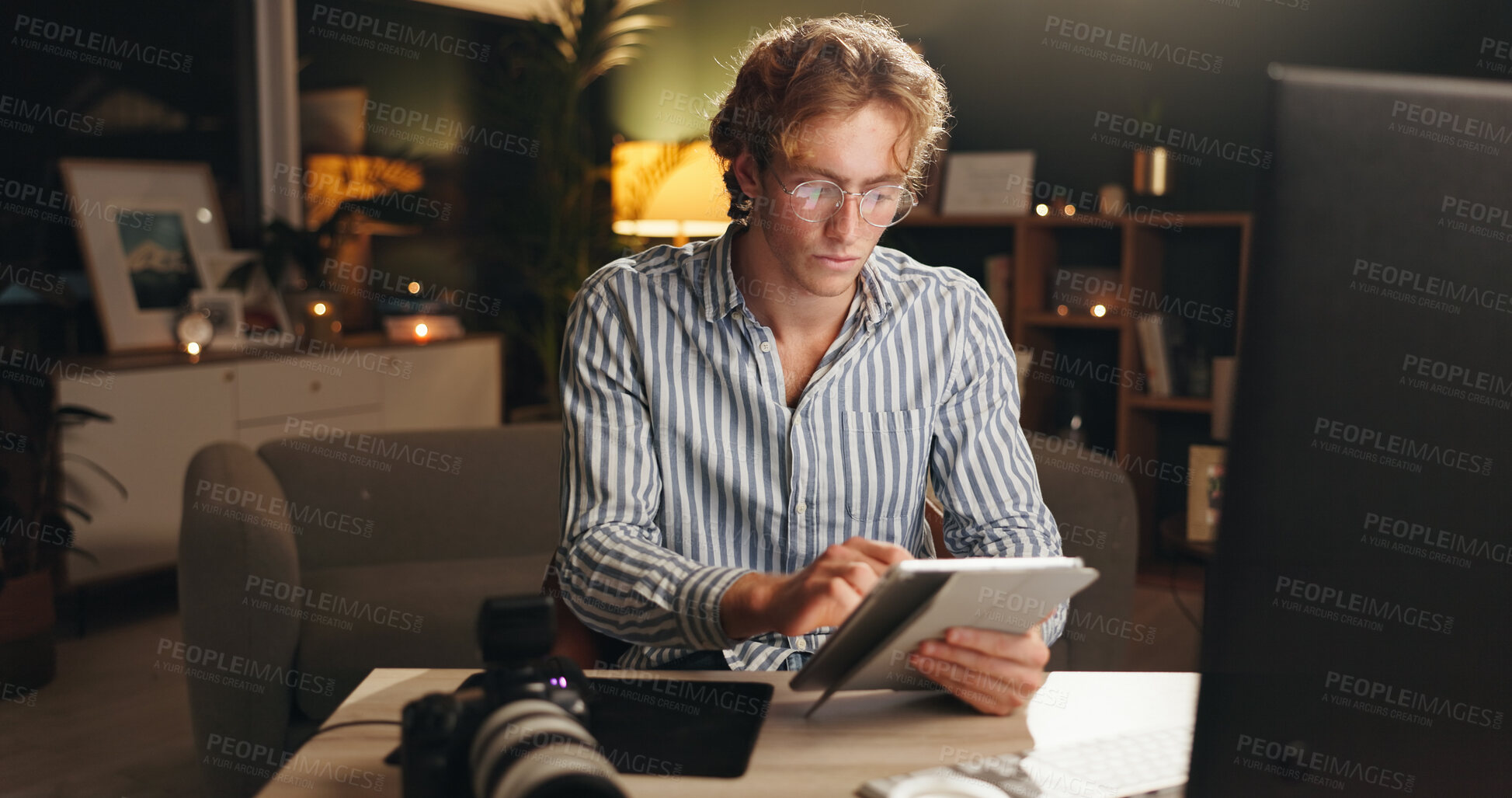 Buy stock photo Man, remote work and tablet in home at night for editing, review images and content creator. Male person, video editor and digital for drawing sketch, check quality and deadline for media production