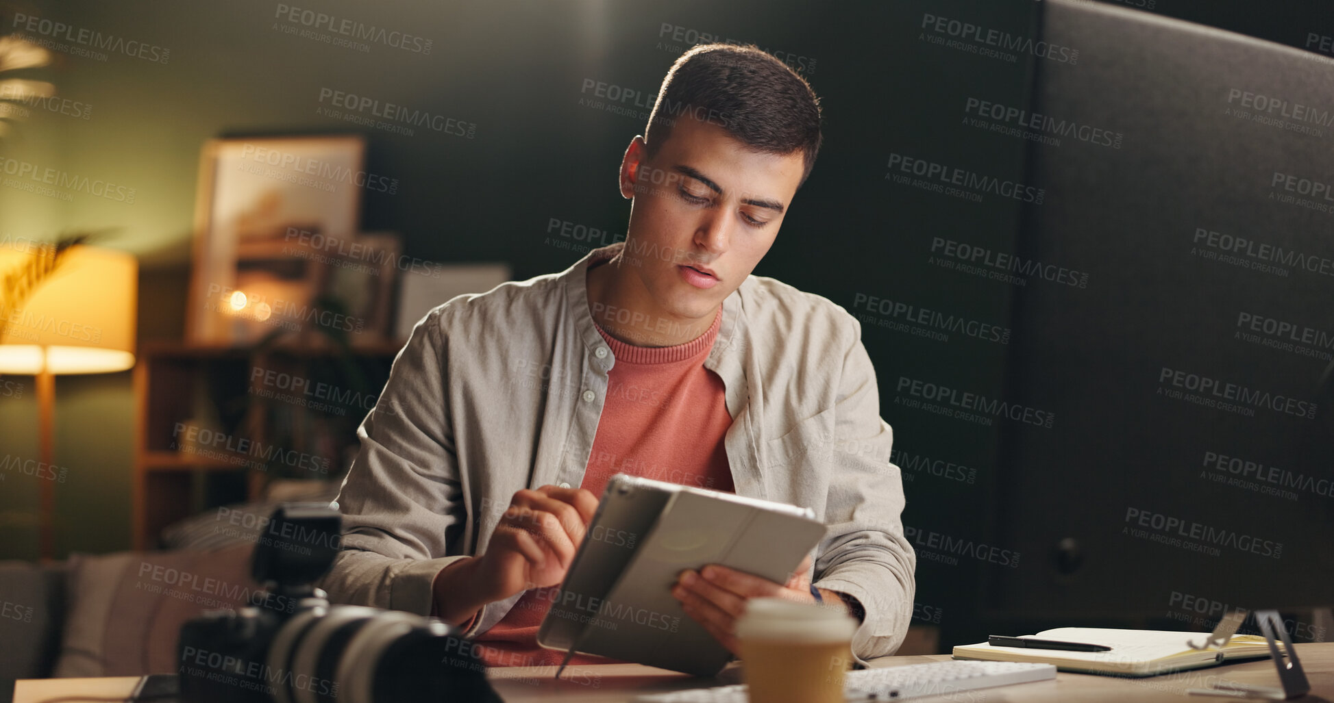 Buy stock photo Man, photographer and tablet in home at night for editing, review images and content creator. Male person, digital and website with creative effects, check quality and deadline for media production