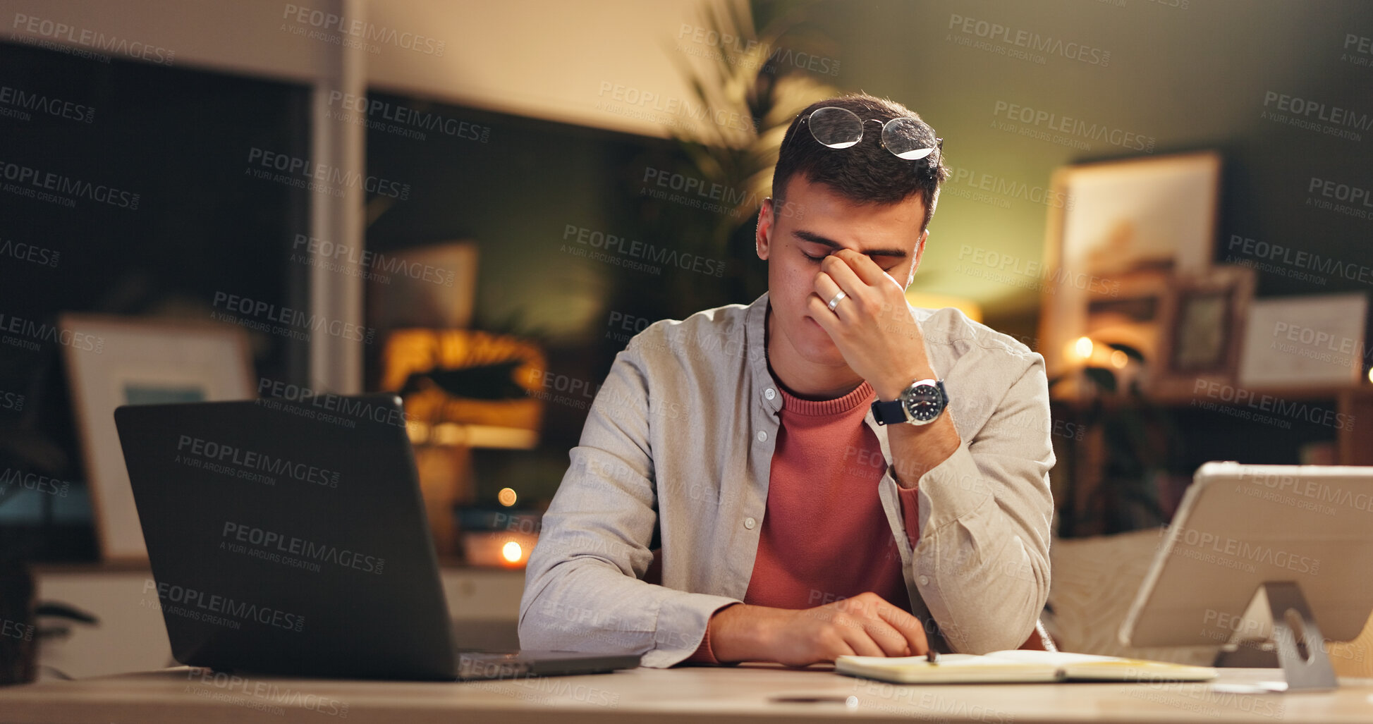 Buy stock photo Night, headache or man in office with laptop, screen fatigue or eye strain in task management. Migraine, glasses or employee in workplace with tech, deadline issue or vision discomfort in late shift.