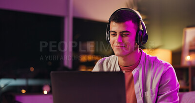 Buy stock photo Laptop, musician and music with headphones, smile and listening to audio track for sound at night. Computer, man and streaming song with tech for content creator, subscription and neon light in home