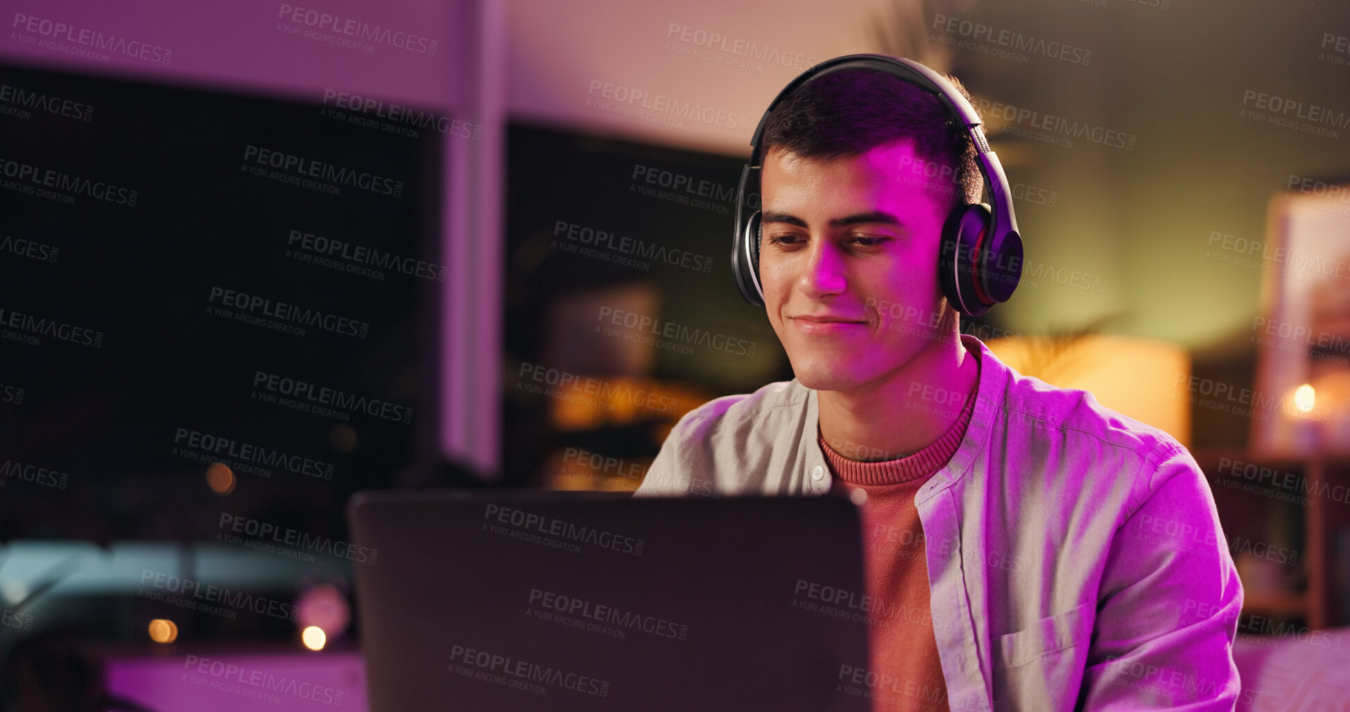 Buy stock photo Laptop, musician and music with headphones, smile and listening to audio track for sound at night. Computer, man and streaming song with tech for content creator, subscription and neon light in home