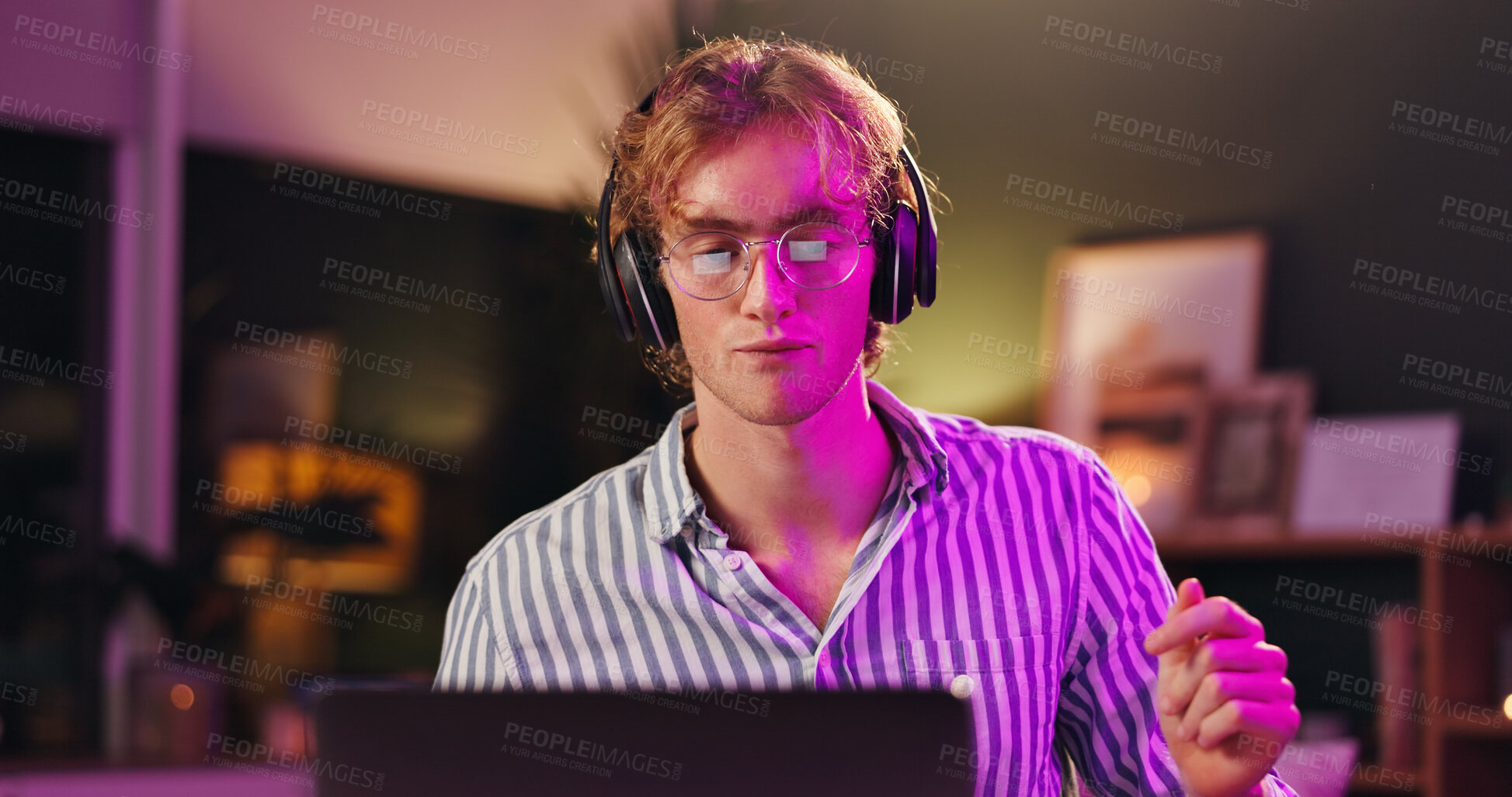 Buy stock photo Laptop, man and music with headphones, smile and listening to audio track for production at night. Computer, person and streaming song with tech for musician, subscription and neon light in home