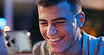 Laugh, night or man in house with phone, online conversation or checking notification on dating app. Chatting, bokeh or person in home with tech, romance match or partner search in late evening.
