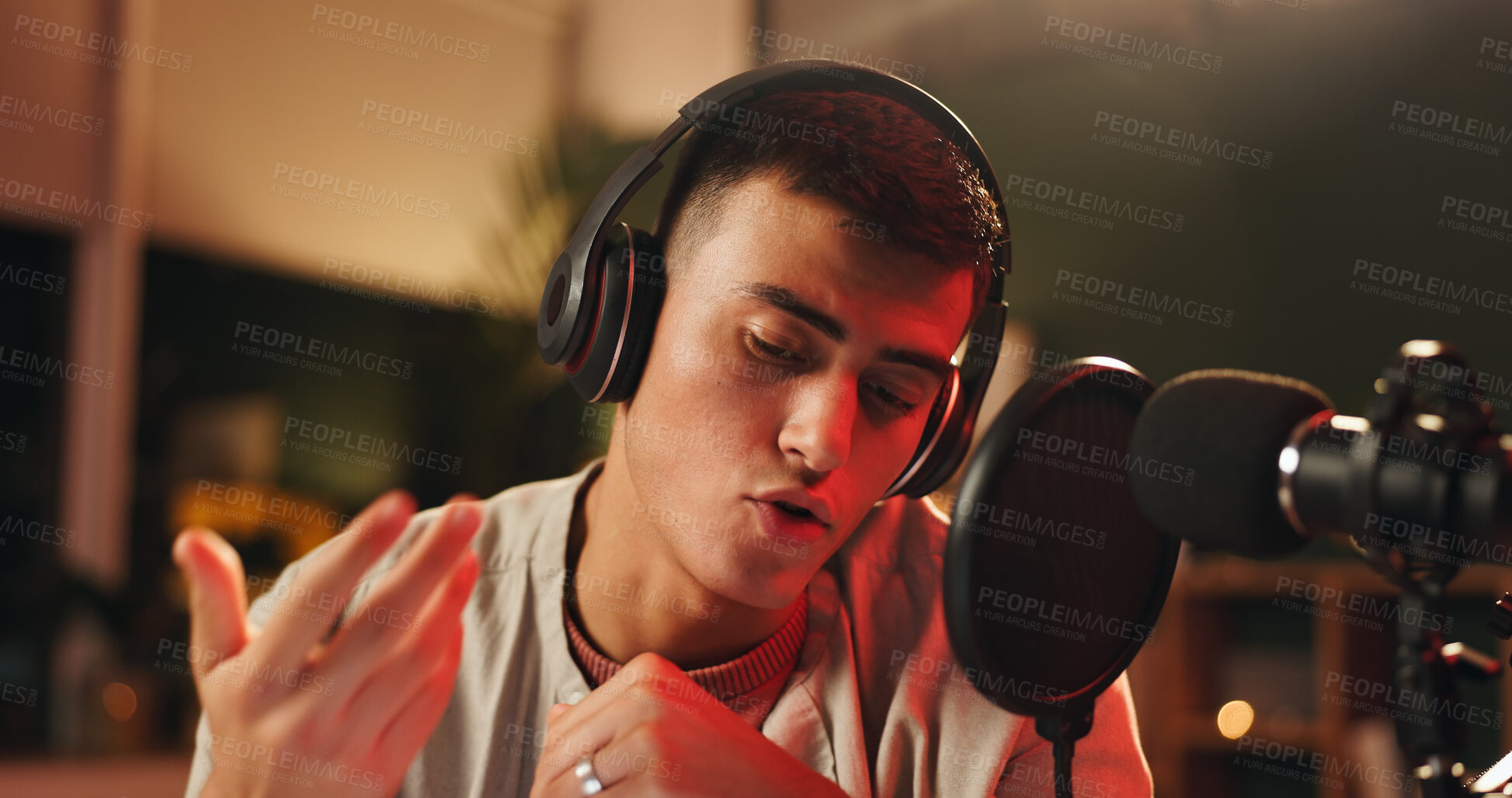 Buy stock photo Influencer, man and microphone for podcast, recording or night broadcast with radio host dj. Live streaming, headphones or streamer reading script for online interview, discussion or talk on tech