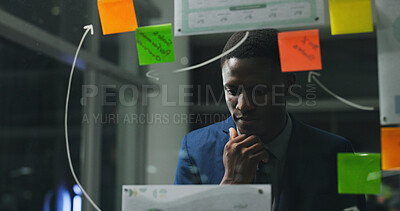 Buy stock photo Glass wall, night or black man in office with thinking, strategy or planning for report. Problem solving, sticky note or employee with insight, idea board or brainstorming deadline on evening shift.