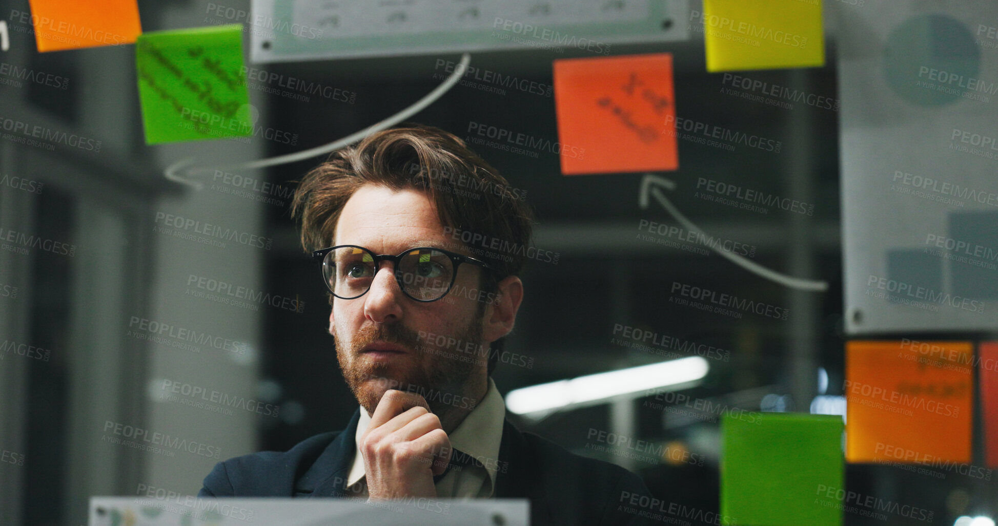 Buy stock photo Glass wall, night or man in office with thinking, strategy or planning for business report. Problem solving, sticky note or employee with insight, idea board or brainstorming on evening shift.