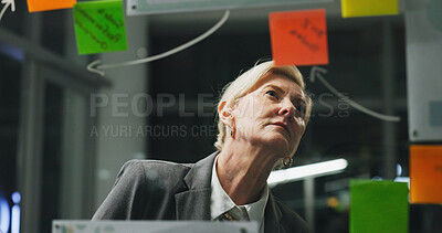 Buy stock photo Glass wall, night or woman in office with review, strategy or planning for report. Problem solving, sticky note or mature employee with insight, idea board or brainstorming deadline on evening shift.