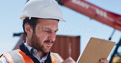 Buy stock photo Engineer, man and reading on construction site with clipboard, inspection or evaluation for project. Person, PPE or checklist outdoor with planning, quality control or report for building compliance.