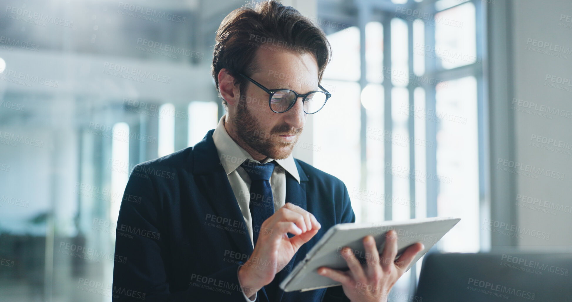 Buy stock photo Review, glasses and man in agency with tablet, online communication and project development for client. Reading, specs and employee in workplace with tech, contract edit and feedback for stakeholder.