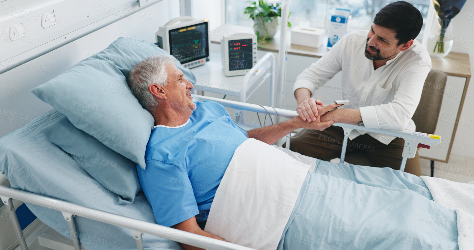 Buy stock photo Elderly patient, son and communication in hospital for visit, emotional support and check up for healing. Care, comfort and senior father with man for health recovery, chat or above in medical center