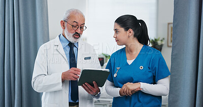 Buy stock photo Doctors, tablet and team with discussion at clinic with review, checklist or insight for medical report. Mentor, man and woman with tech, application and feedback for healthcare services at hospital