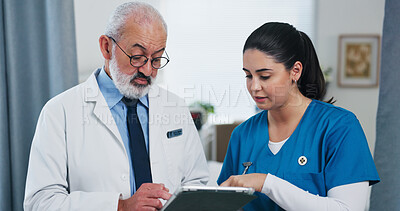 Buy stock photo Doctors, tablet and team with discussion at hospital with review, checklist or insight for medical report. Mature mentor, man and woman with tech, app and feedback for healthcare services at clinic
