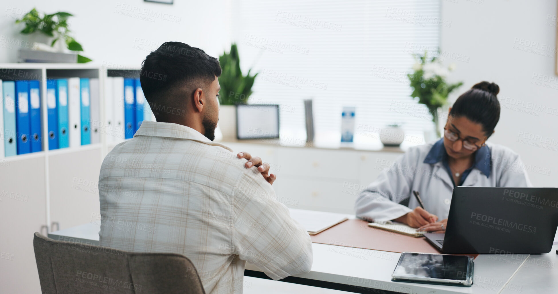 Buy stock photo Doctor, consultation and shoulder pain in hospital, healthcare question or writing prescription. People, medical worker and patient with injury, checkup or assessment report with symptoms in clinic