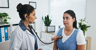 Buy stock photo Doctor, women and listen in office with stethoscope, heart assessment and cardiology exam for advice. People, healthcare worker or patient in clinic with medical equipment, chest evaluation and help.