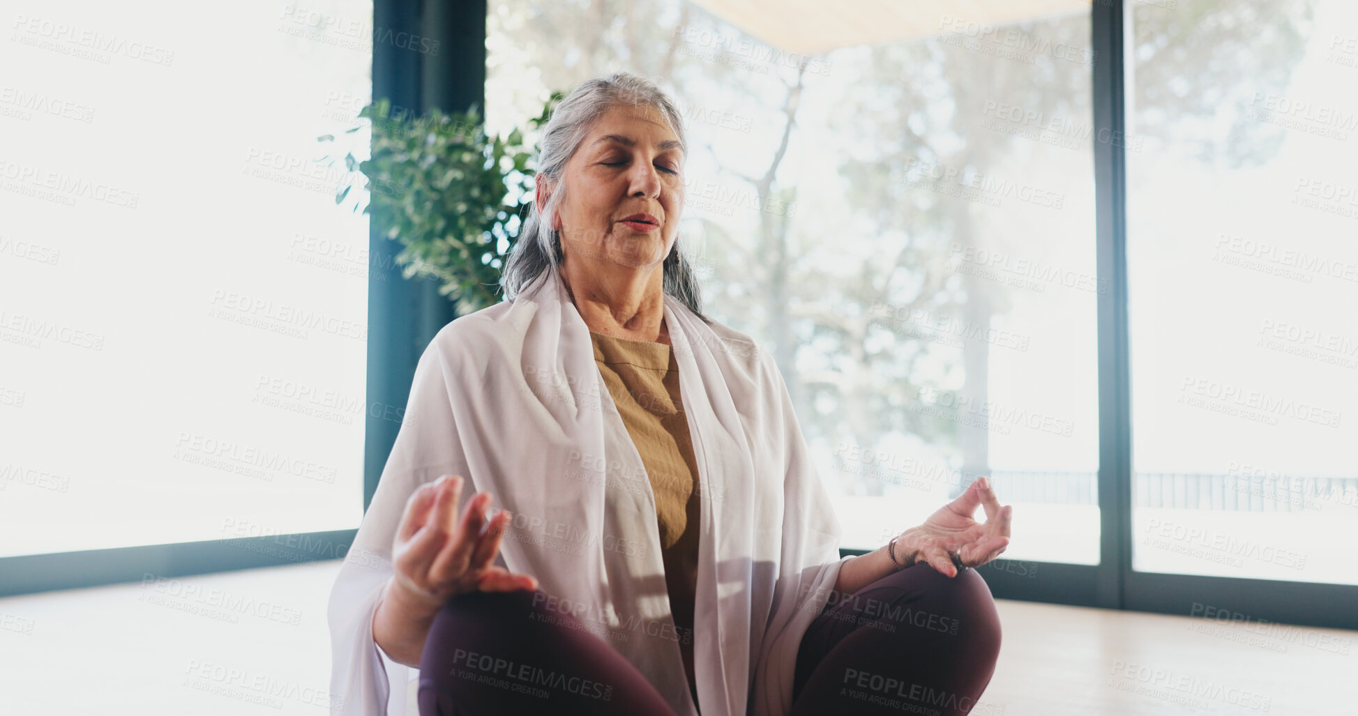 Buy stock photo Yoga, elderly woman and meditation in studio for stress relief, grounding practice or mindfulness. Zen, old person and lotus pose on mat for mental health, inner peace or holistic wellness with space