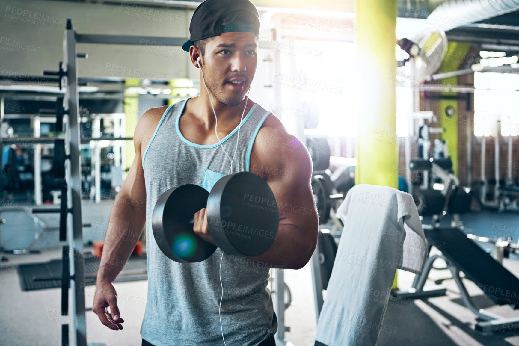 Buy stock photo Strong, dumbbells and man in gym, training and endurance for muscle development. Equipment, fitness and person in wellness center, energy or exercise for health, lifting weights or flare with workout
