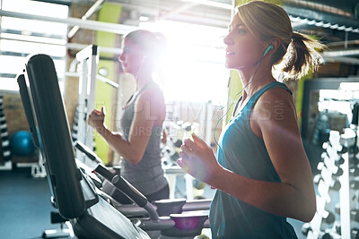 Buy stock photo Gym, earphones and women on treadmill, active and training routine with music, running and wellness. Cardio, flare and people with tech for audio, workout and fitness on equipment in health club