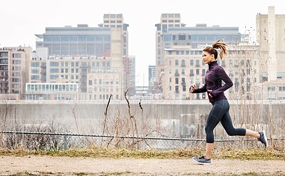 Buy stock photo Running, athlete and fitness with woman in city for workout, cardio challenge and health. Exercise practice, energy and wellness with person outdoor for runner training, race performance and sports