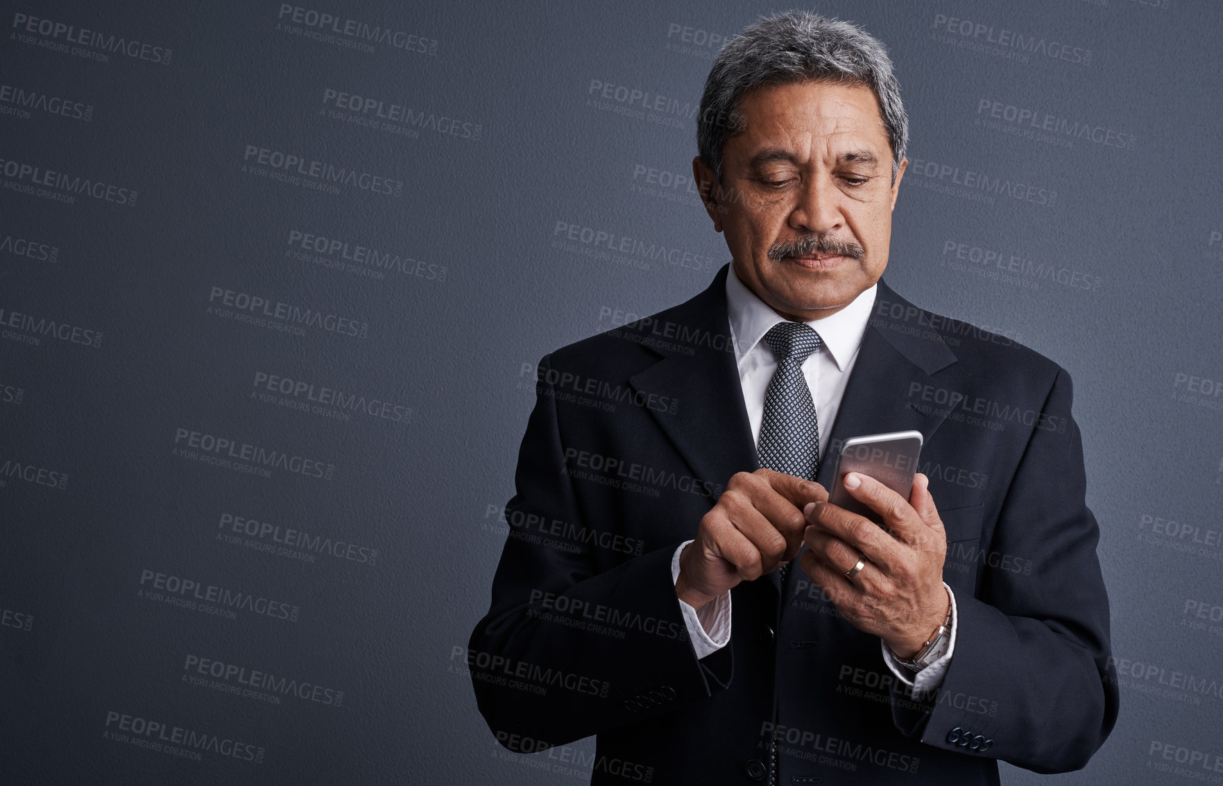 Buy stock photo Phone, reading and professional with business man in studio for realtor negotiation, network or chat. Communication, virtual property advisor or connection with mature person on dark background space