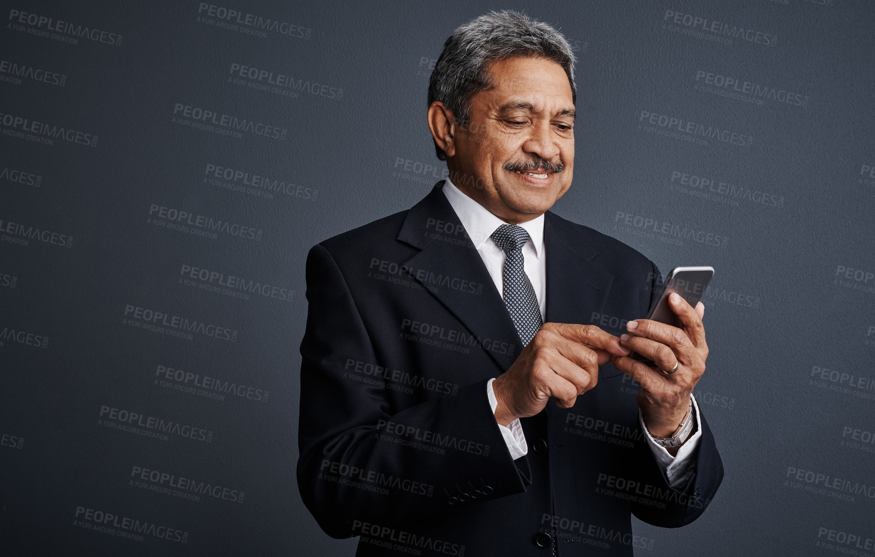 Buy stock photo Mature, businessman and studio with phone for social media, network or chat on a gray background. Happy man, employee or smile with mobile smartphone for online app, texting or connection on space