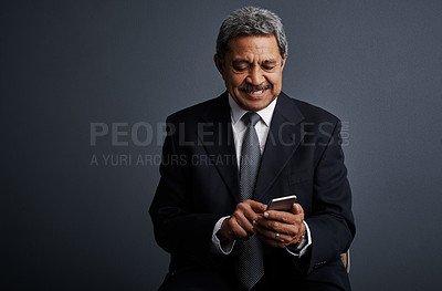 Buy stock photo Phone, search and professional with business man in studio for realtor negotiation, network or chat. Communication, virtual property advisor or connection with mature person on dark background space