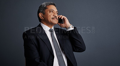 Buy stock photo Phone call, listen and professional with business man in studio for realtor negotiation, network or chat. Communication, virtual property advisor or connection with mature person on dark background