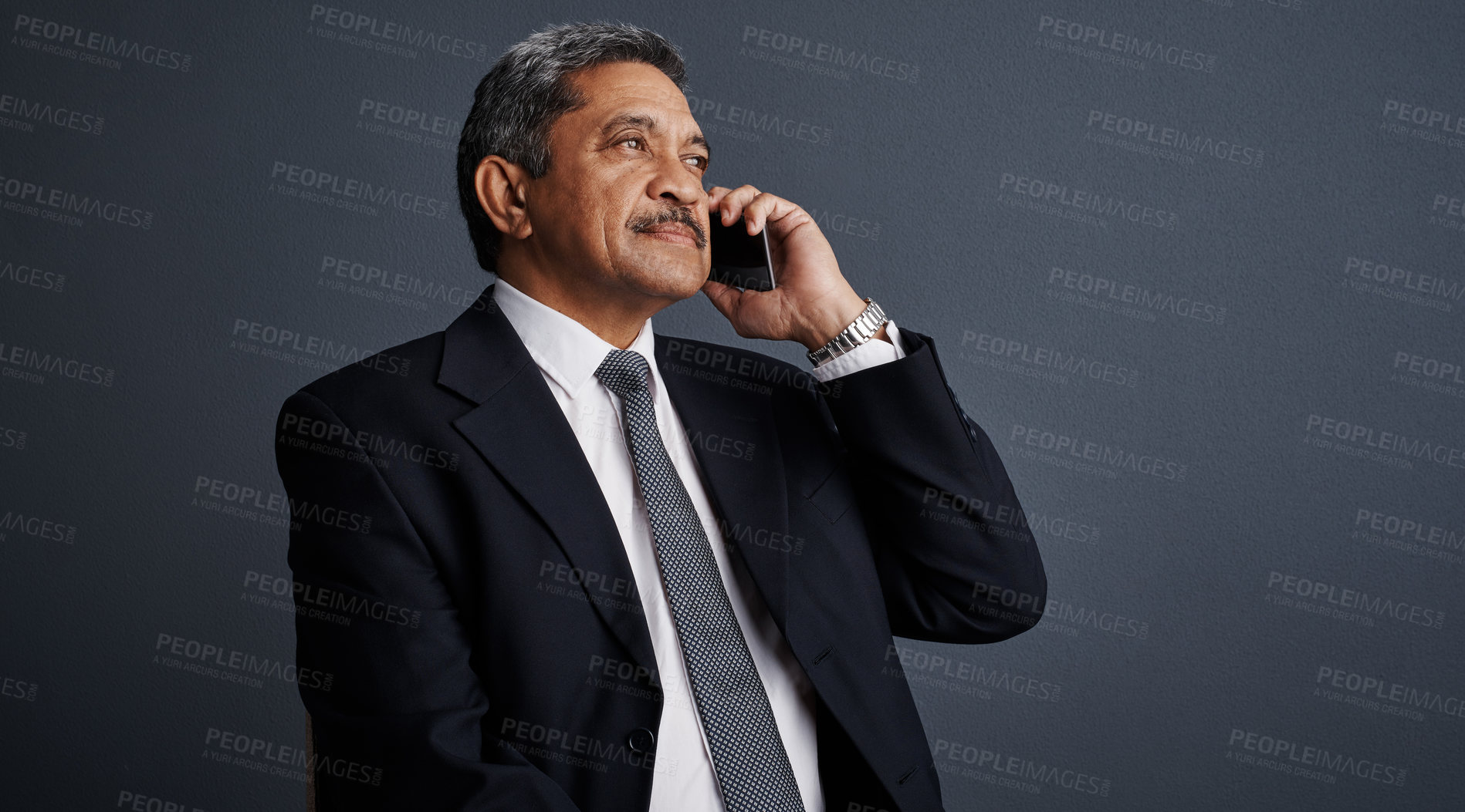 Buy stock photo Phone call, listen and professional with business man in studio for realtor negotiation, network or chat. Communication, virtual property advisor or connection with mature person on dark background