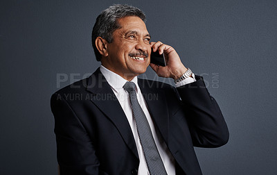 Buy stock photo Phone call, smile and professional with business man in studio for realtor negotiation, network or chat. Communication, virtual property advisor and connection with mature person on dark background