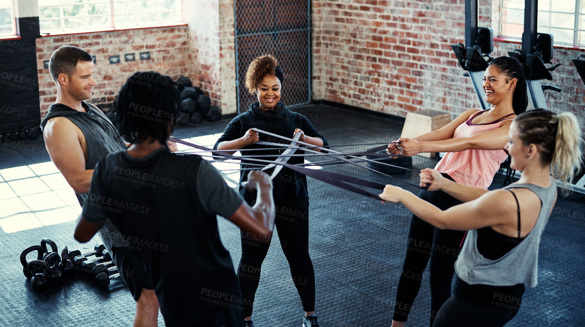 Buy stock photo Resistance band, fitness and people in gym for training, teamwork and challenge. Health benefits, men and women in wellness center, exercise and equipment for endurance, workout and power mindset