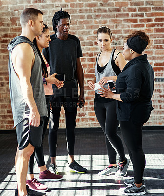 Buy stock photo Workout, group and conversation with phone at gym for exercise break, monitor fitness or support. Men, women and talking with smartphone at wellness club to share advice and track training progress