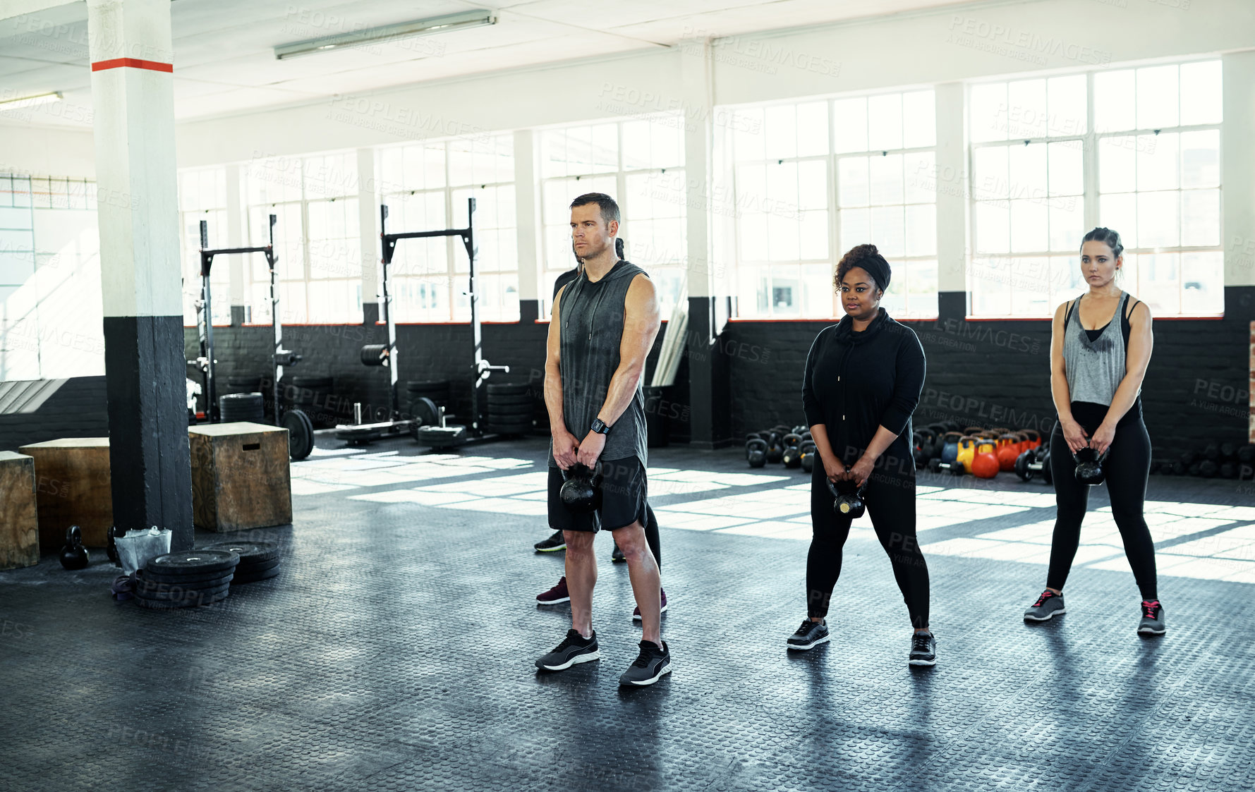 Buy stock photo Power, kettlebell and people in gym, fitness and support for body development. Routine, men and women in wellness center, exercise and equipment for health benefits, challenge and strength training