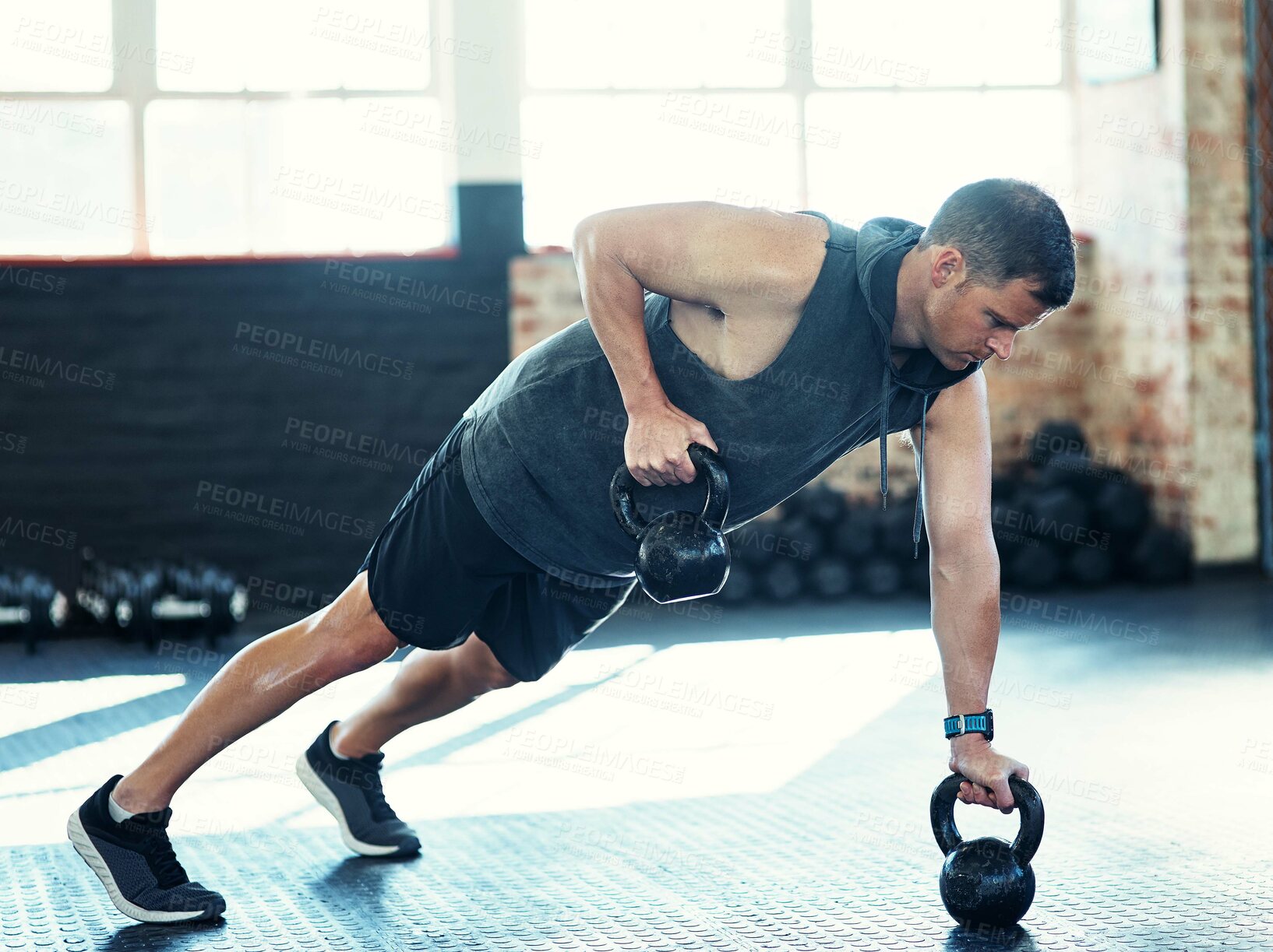 Buy stock photo Man, push up and kettlebell for muscle at gym with fitness, balance or power on floor for workout. Person, bodybuilder and exercise equipment for challenge, strong and training with weights at club