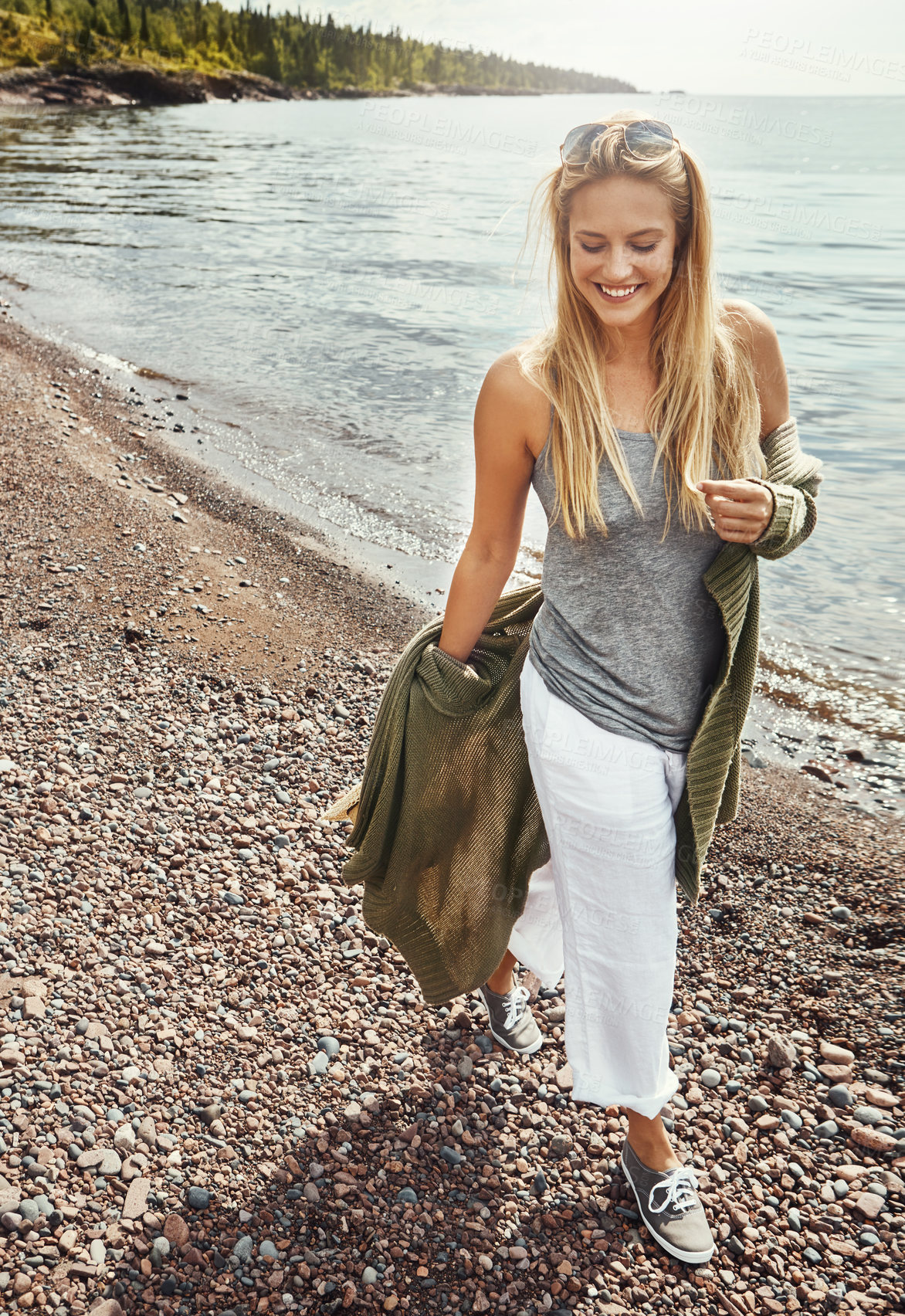 Buy stock photo Woman, walking and happy at beach, travel and laughing on adventure, tourism or fresh air on holiday. Outdoor, traveler and person with smile in nature, thinking and break on vacation, sea and space
