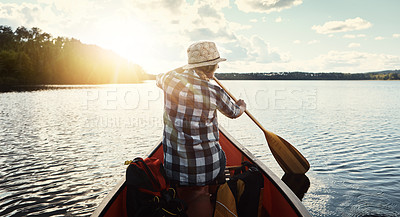Buy stock photo Canoeing, lake and rowing with woman on holiday, vacation or adventure for water sports. Travel, paddle and person on boat outdoor with sunshine for summer, exploration and fitness with back view