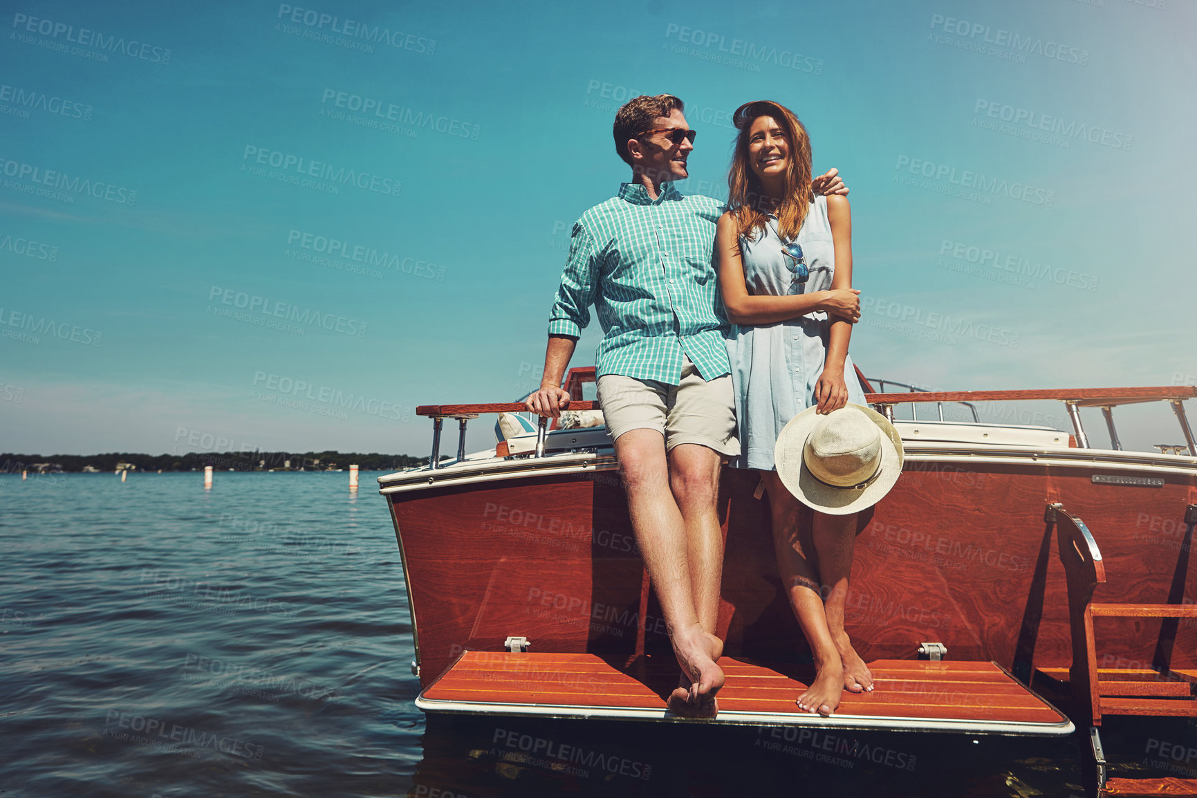 Buy stock photo Ocean, couple and relax with smile on boat for travel adventure, anniversary trip or luxury cruise. Sunshine, love and people with hug on yacht for romantic date, summer getaway or bonding with space
