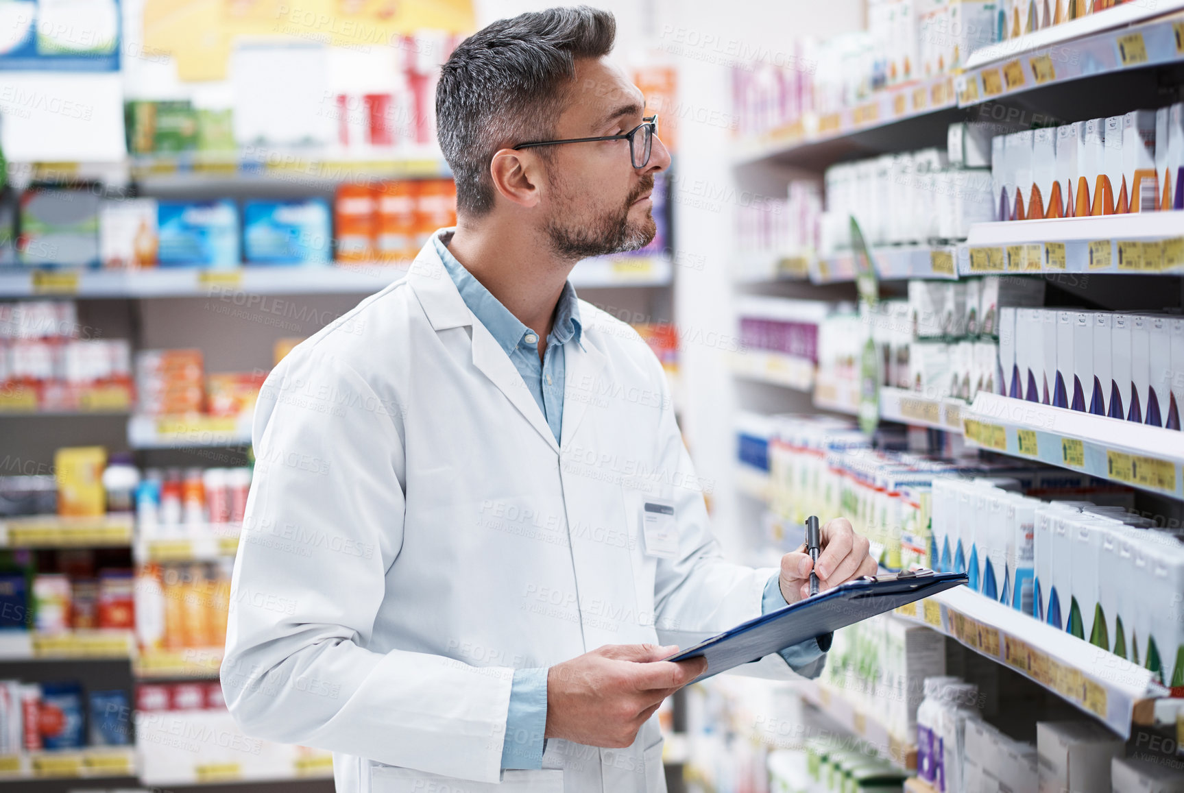 Buy stock photo Pharmacist, man and writing on clipboard in shop for inventory, pills quantity and product info. Professional, mature person and stock count checklist in pharmacy for prescription accuracy and retail